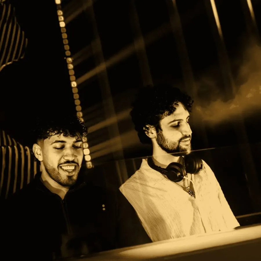 Two DJs side by side in the booth